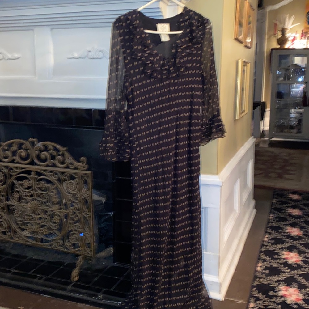 Black silk dress with sheer sleeves w/ruffles at elbows and neckline. Romantic!